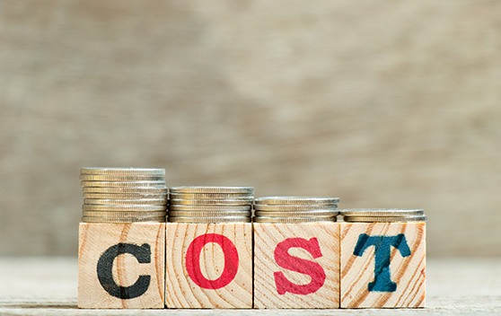 Wooden blocks spelling out “cost”