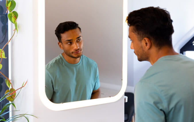 a man looking in a mirror