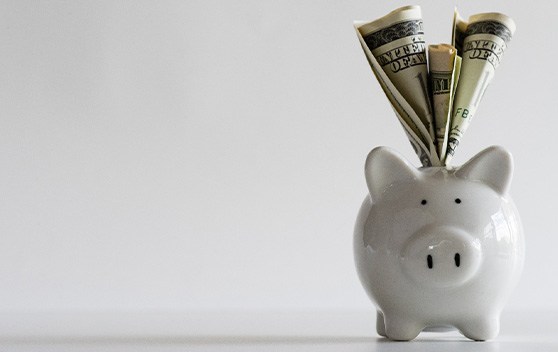 Dental implant on stack of cash