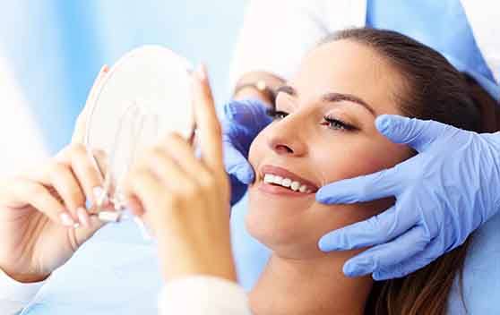 A woman admiring the results of her root canal